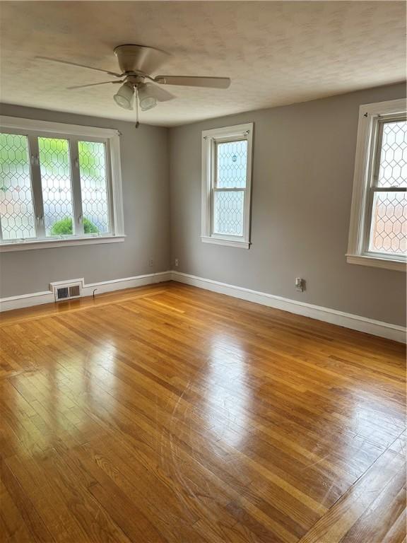 23 Pengrove St, Cranston, RI 02920 - spare room with wood finished floors, a ceiling fan, and baseboards