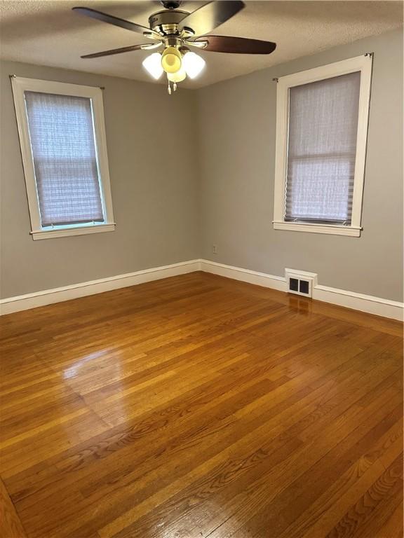 23 Pengrove St, Cranston, RI 02920 - unfurnished room featuring ceiling fan, wood finished floors, baseboards, and a textured ceiling