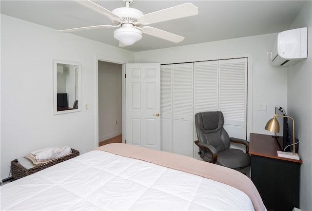 bedroom featuring a closet, a ceiling fan, and a wall mounted AC