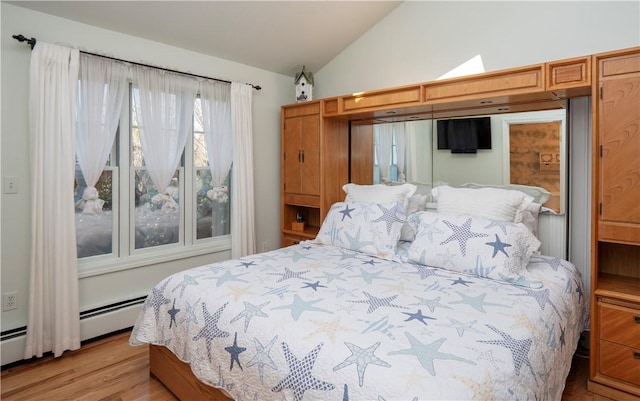 bedroom featuring lofted ceiling and light wood-type flooring
