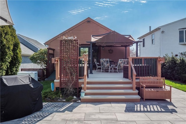 rear view of house with a deck, a pergola, and outdoor dining area