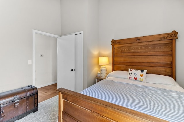 bedroom featuring baseboards and wood finished floors
