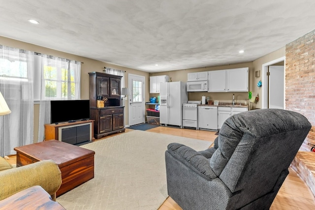 living area featuring light wood-style floors and recessed lighting