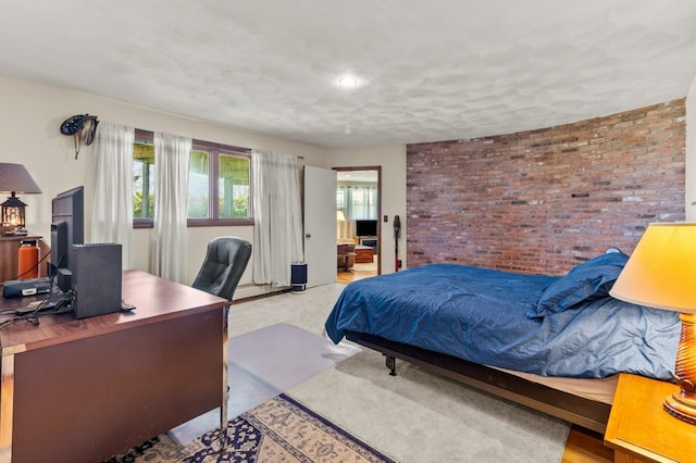 bedroom featuring brick wall