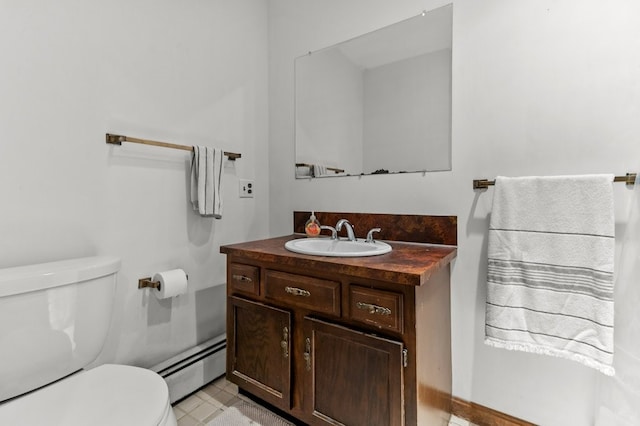 half bathroom featuring vanity, a baseboard heating unit, and toilet