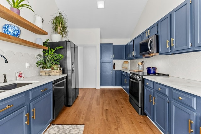 kitchen featuring open shelves, appliances with stainless steel finishes, a sink, backsplash, and blue cabinets