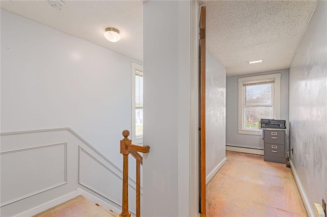 141 Canal St, Westerly, RI 02891 - hall featuring an upstairs landing, a decorative wall, light carpet, a textured ceiling, and a baseboard radiator
