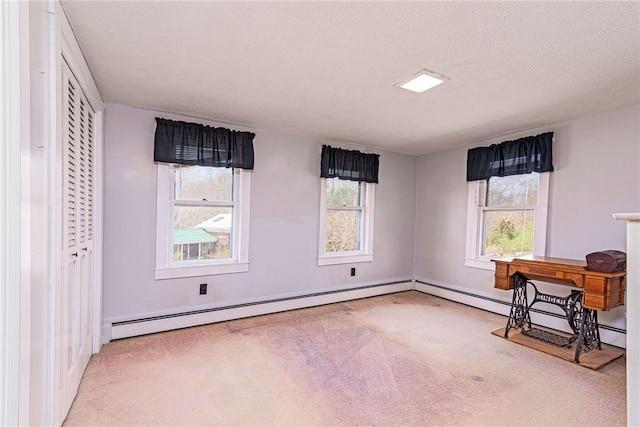 141 Canal St, Westerly, RI 02891 - unfurnished office featuring a baseboard heating unit, a textured ceiling, carpet floors, and plenty of natural light