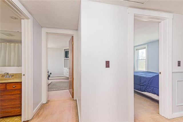 141 Canal St, Westerly, RI 02891 - hall with light colored carpet, baseboards, and a sink