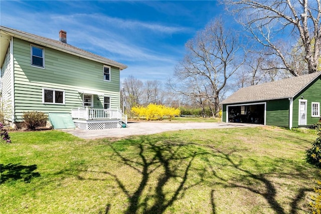 141 Canal St, Westerly, RI 02891 - back of house featuring a wooden deck, a garage, an outdoor structure, a yard, and a chimney
