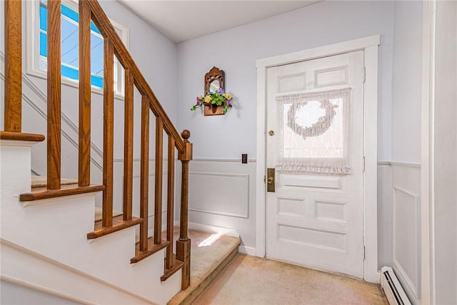 141 Canal St, Westerly, RI 02891 - foyer featuring a decorative wall, baseboard heating, stairway, and light colored carpet