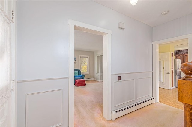 141 Canal St, Westerly, RI 02891 - hallway featuring tile patterned floors, a baseboard heating unit, and carpet flooring