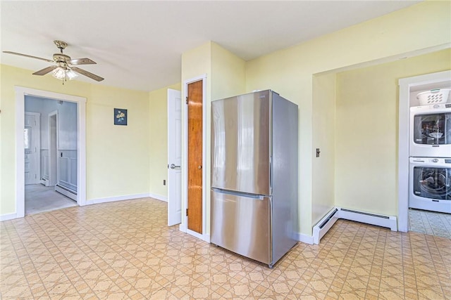 141 Canal St, Westerly, RI 02891 - kitchen featuring light floors, stacked washer and dryer, baseboard heating, and freestanding refrigerator