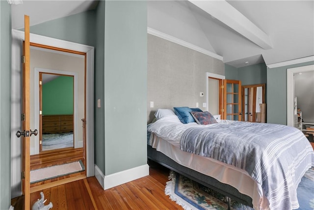 bedroom featuring lofted ceiling, wood finished floors, french doors, and baseboards