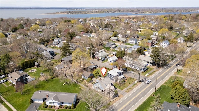 drone / aerial view featuring a residential view and a water view