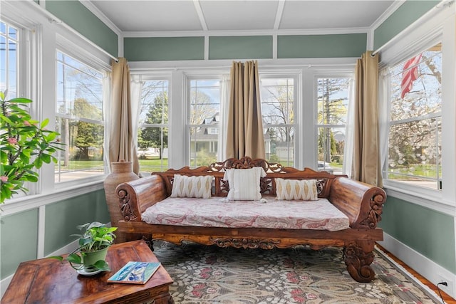 sunroom with baseboards and a healthy amount of sunlight