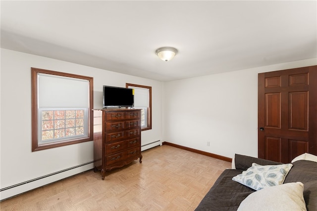 living area with baseboards and a baseboard heating unit