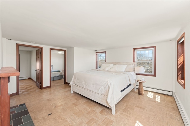 bedroom featuring baseboards and a baseboard radiator