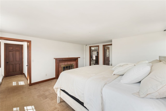bedroom featuring baseboards and a fireplace