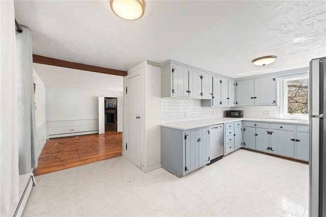 kitchen featuring appliances with stainless steel finishes, a baseboard heating unit, decorative backsplash, and baseboard heating