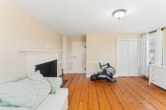sitting room featuring a fireplace and wood-type flooring