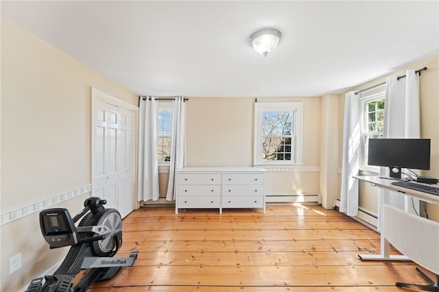 office area with light wood finished floors and baseboard heating