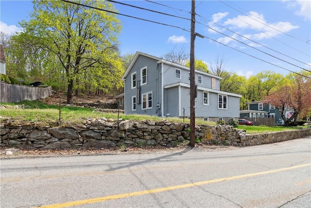 view of front of home featuring fence