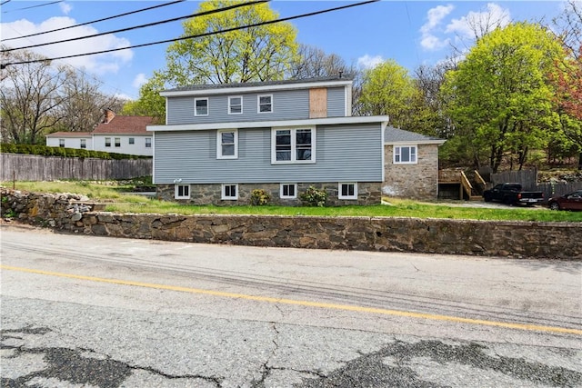 view of front of home featuring fence