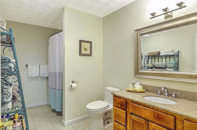 bathroom featuring tile patterned floors, baseboards, toilet, and vanity