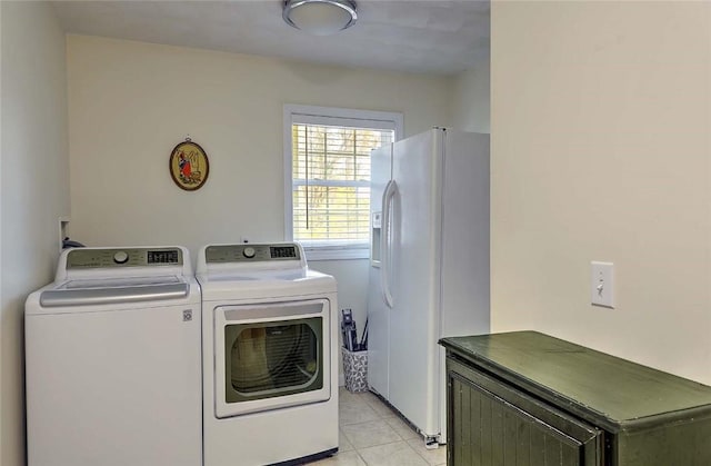 laundry area featuring light tile patterned floors and washer and clothes dryer