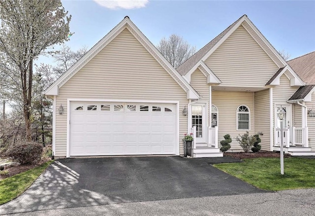 view of front of house featuring aphalt driveway and a garage