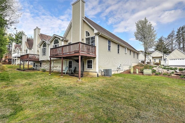 back of house featuring a deck, a yard, a chimney, and central air condition unit