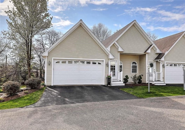 ranch-style home with aphalt driveway and a garage