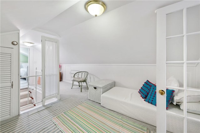 sitting room featuring carpet and vaulted ceiling
