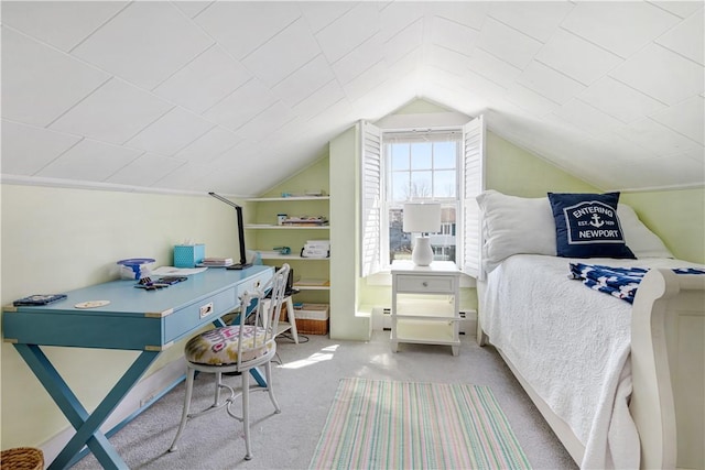 bedroom with a baseboard heating unit, carpet flooring, and vaulted ceiling
