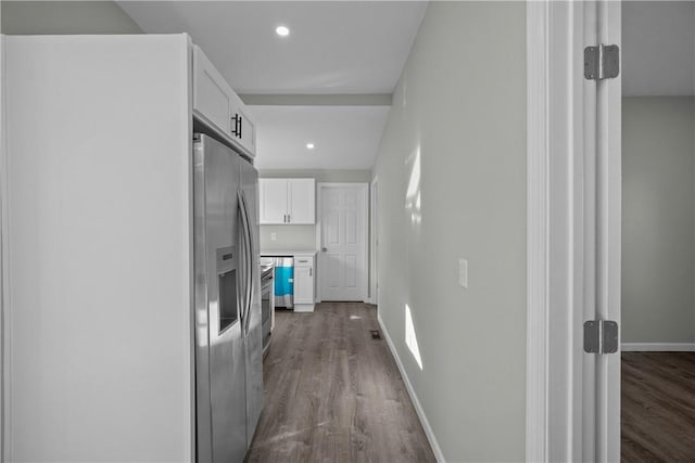 hall featuring dark wood-style flooring, recessed lighting, and baseboards