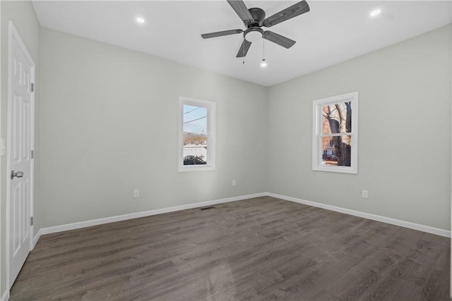 spare room with baseboards, recessed lighting, a ceiling fan, and dark wood-type flooring