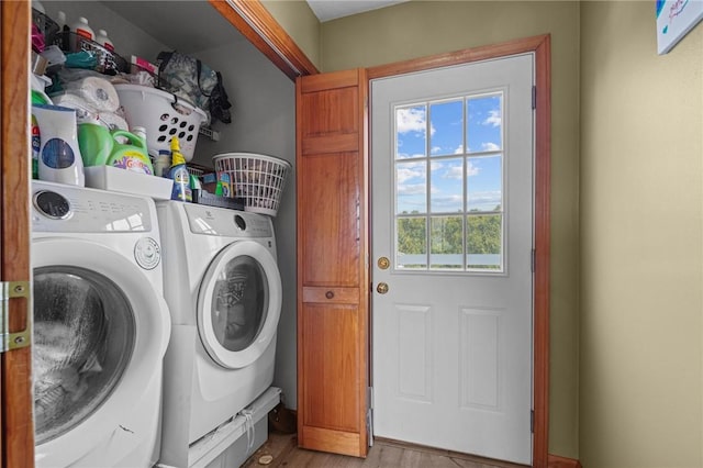 washroom featuring wood finished floors, separate washer and dryer, and laundry area