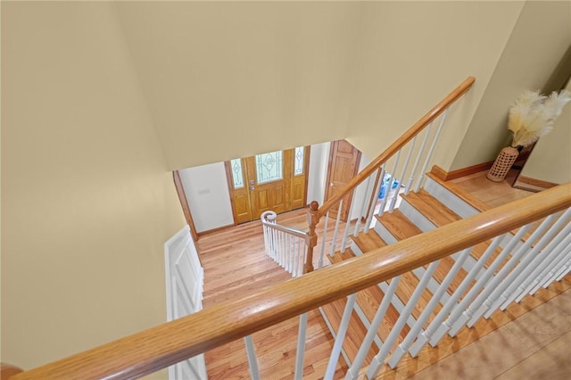 stairs featuring wood finished floors and baseboards