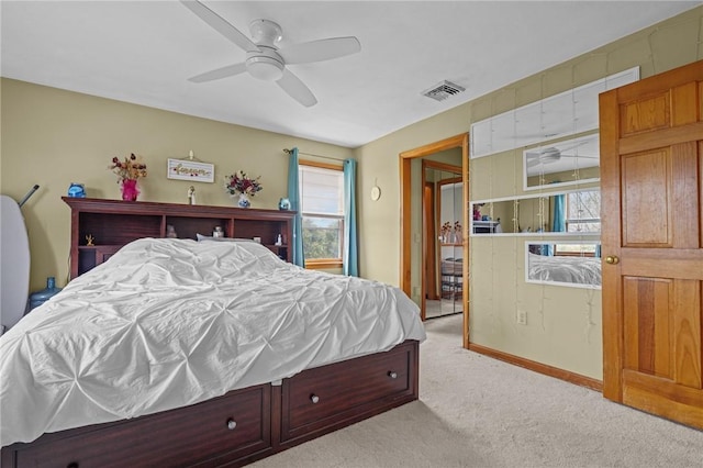 bedroom with visible vents, ceiling fan, and light carpet