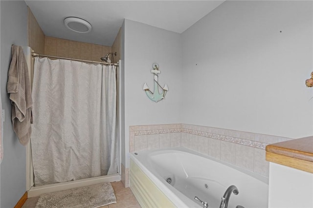 bathroom featuring tile patterned floors, baseboards, a stall shower, and a whirlpool tub