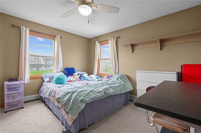 carpeted bedroom with ceiling fan, baseboards, and multiple windows