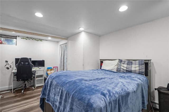bedroom featuring baseboard heating, recessed lighting, wood finished floors, and baseboards
