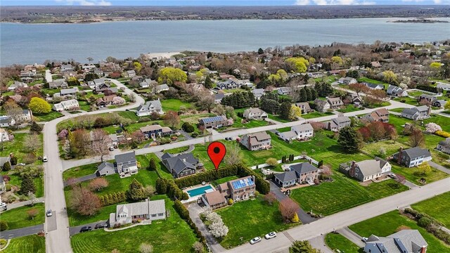 drone / aerial view featuring a residential view and a water view
