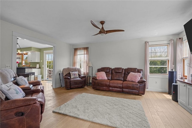 living room featuring light wood-style floors and ceiling fan