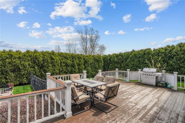 wooden deck featuring outdoor dining space and grilling area