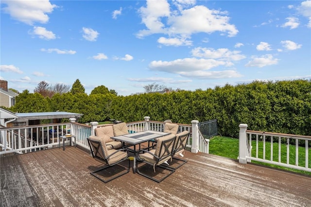 wooden terrace with outdoor dining area
