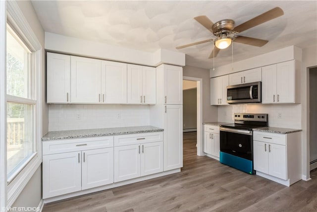 22 T Parker Rd, Foster, RI 02825 - kitchen featuring light stone countertops, white cabinets, backsplash, and stainless steel appliances