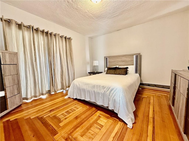 172 Park Ave, Woonsocket, RI 02895 - bedroom with a textured ceiling and wood finished floors