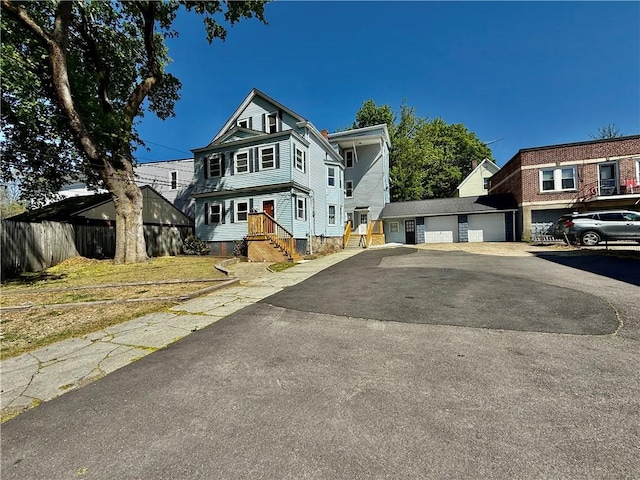 172 Park Ave, Woonsocket, RI 02895 - view of front facade with a garage and fence